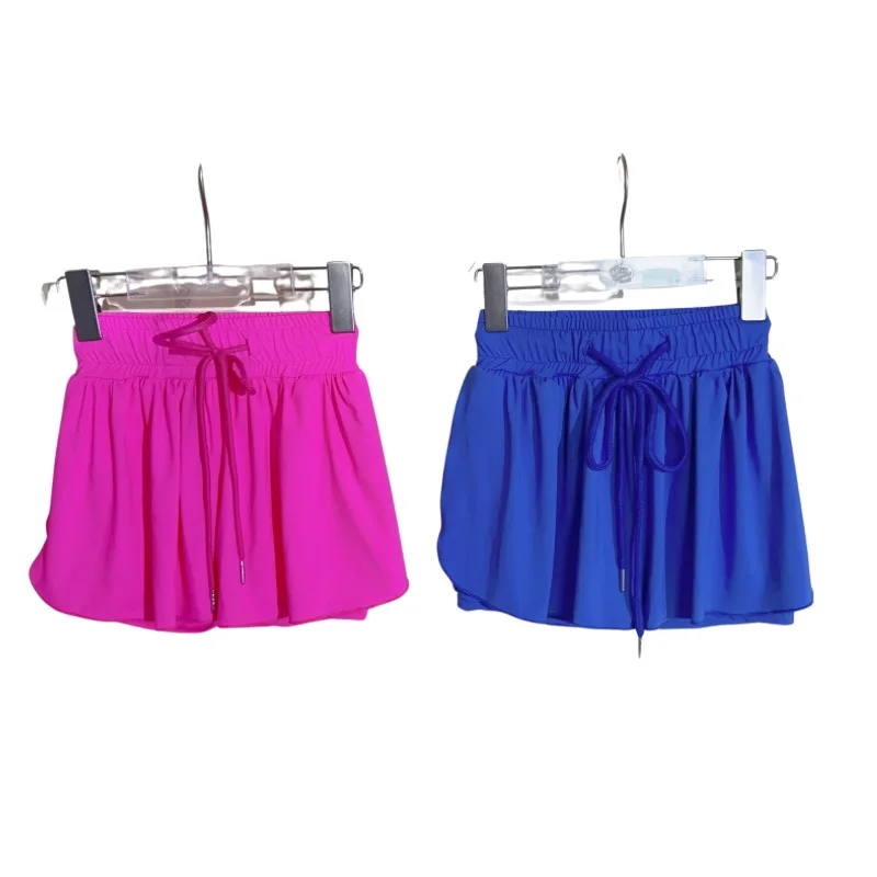 Children practicing yoga outdoors surrounded by nature, promoting wellness-focused products for B2B wholesale in kids' active lifestyle markets.