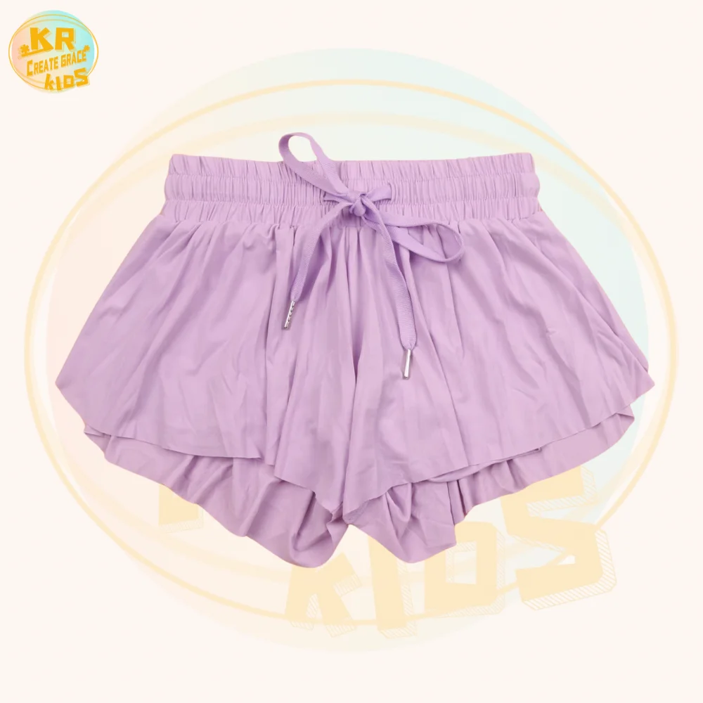 Group of girls in stylish activewear on green grass, showcasing high-quality wholesale apparel perfect for B2B retailers and distributors.