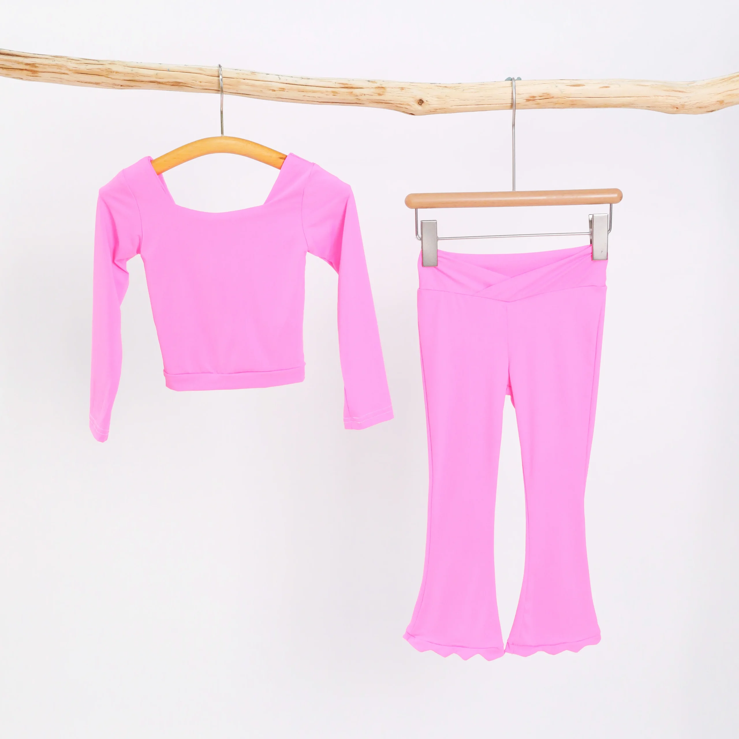 Wholesale youth activewear sets displayed on mannequins, featuring vibrant colors and durable fabrics, perfect for retail businesses.